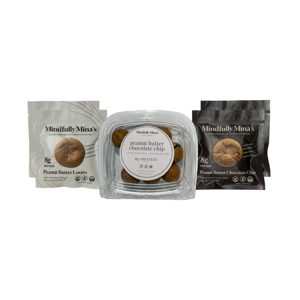 Three Mindfully Mina’s peanut butter products side by side: 2 white pouches of Peanut Butter Lovers protein cookies, a clear container of peanut butter chocolate chip protein balls, and 2 black pouches of Peanut Butter Chocolate Chip protein cookies. All are labeled “8g protein.”