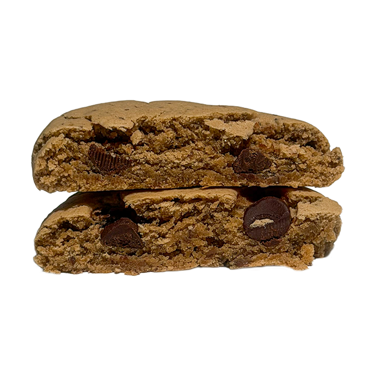 A tahini chocolate chip protein cookie cut in half and stacked, showing a soft, tan interior with large pieces of dark chocolate.