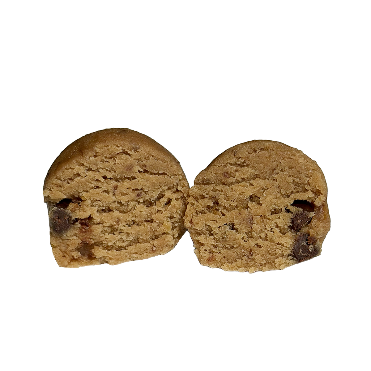 A tahini chocolate chip protein ball cut in half, showing a soft, golden-tan interior with small chocolate chips scattered through it.